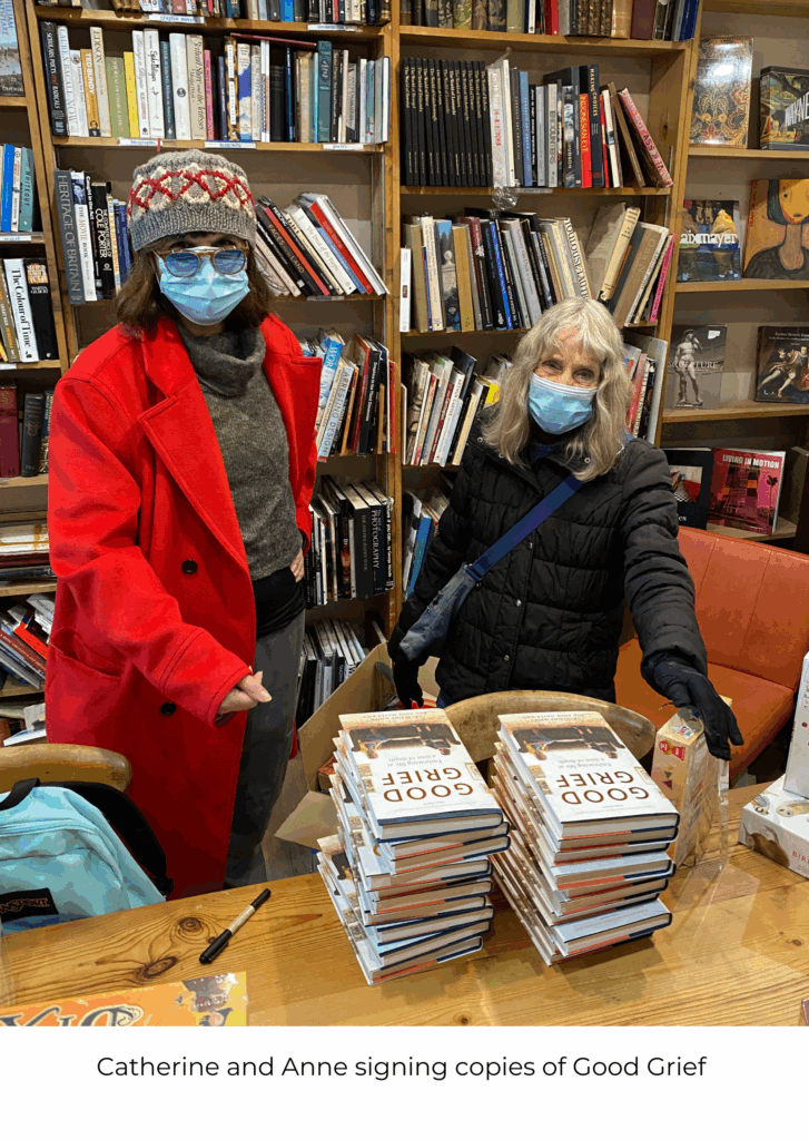 Catherine and Anne wearing infection masks as they sign copies of their book Good Grief.
